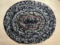 Black white oval rug with rainbow thread