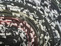 Black white oval rug with rainbow thread