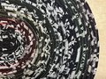 Black white oval rug with rainbow thread