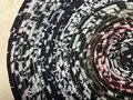Black white oval rug with rainbow thread