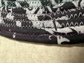 Black white oval rug with rainbow thread