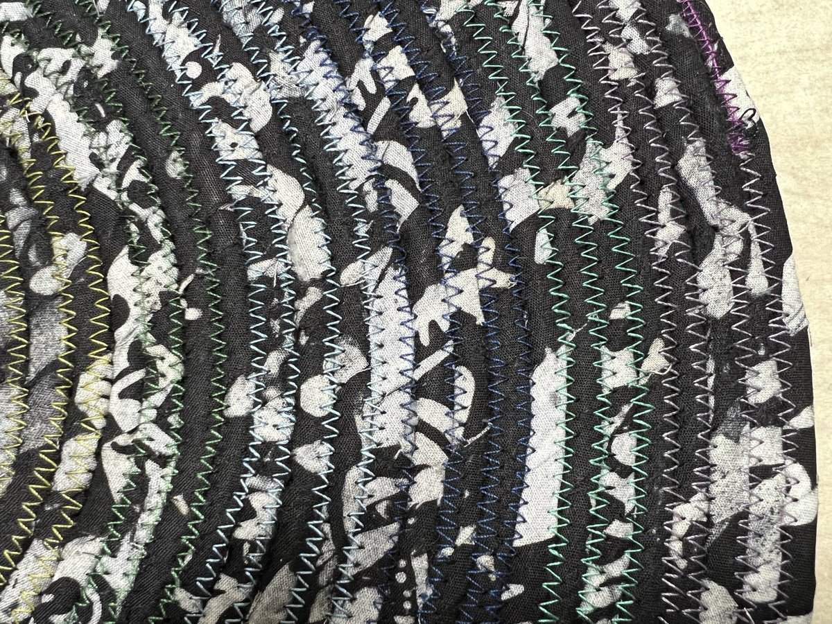 Black white oval rug with rainbow thread