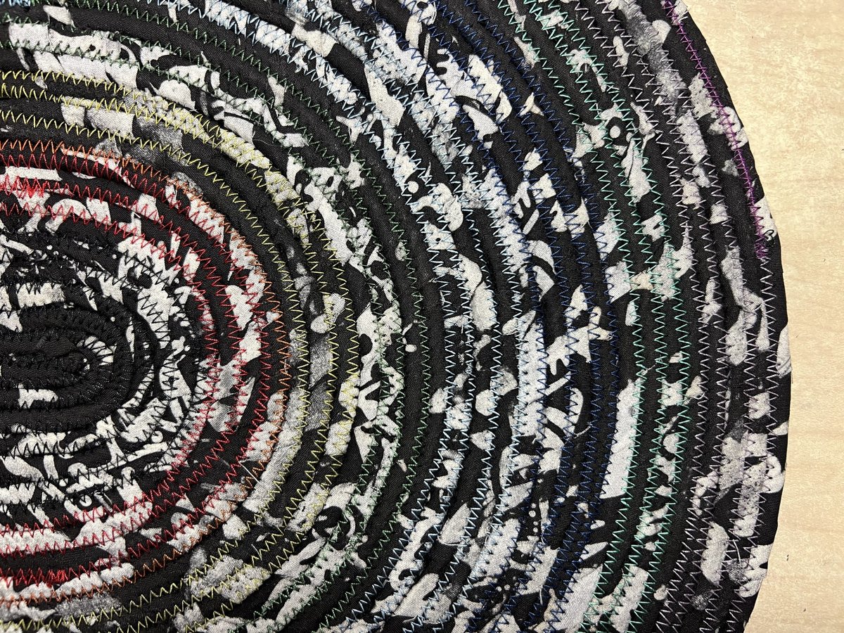 Black white oval rug with rainbow thread