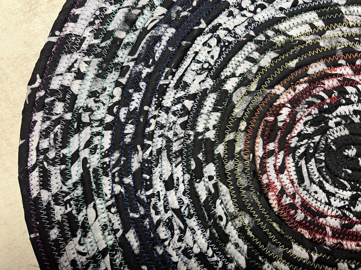 Black white oval rug with rainbow thread