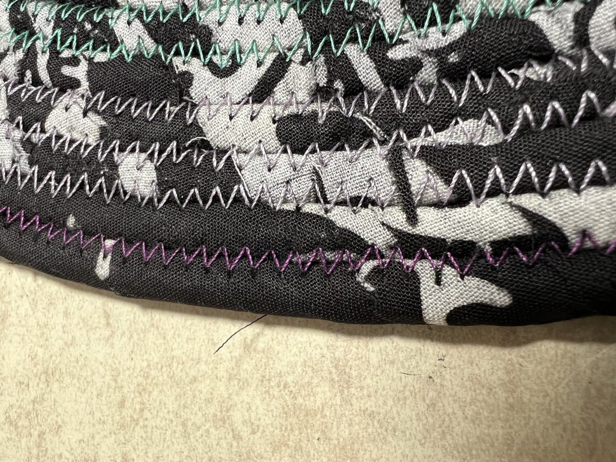 Black white oval rug with rainbow thread