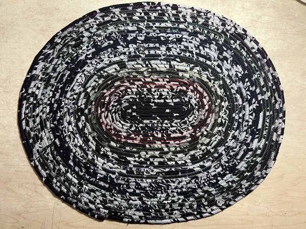 Black white oval rug with rainbow thread
